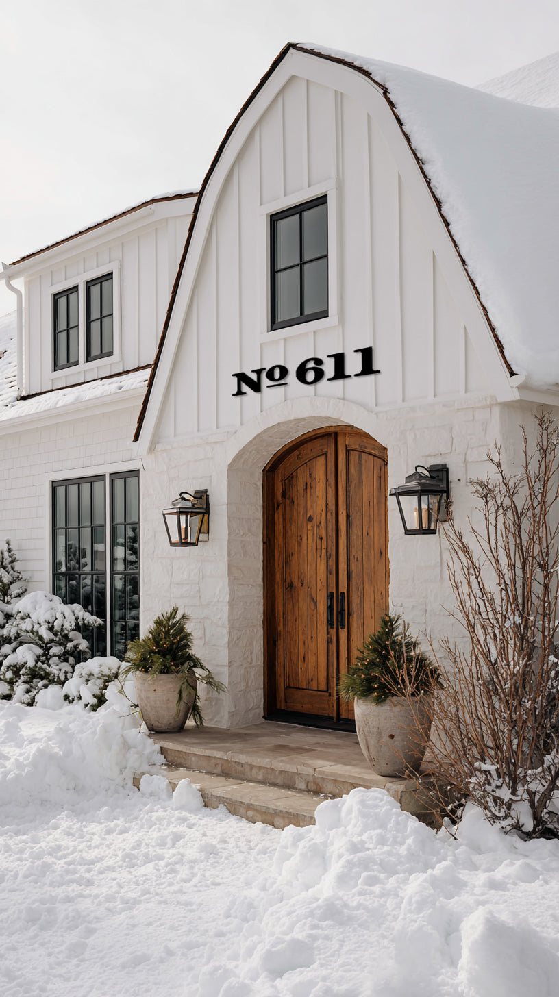 White house with wooden door and snow-covered ground extra large black house numbers