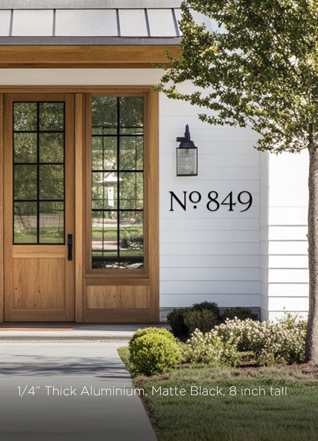 Modern house exterior with wooden door and decorative address numbers in black metal 8 inch tall on white wall