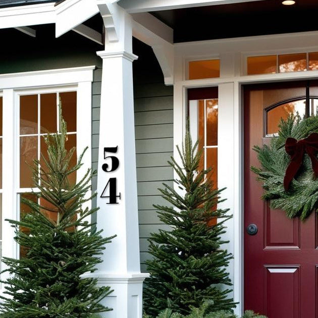 Front door of a house with decorative wreath and greenery