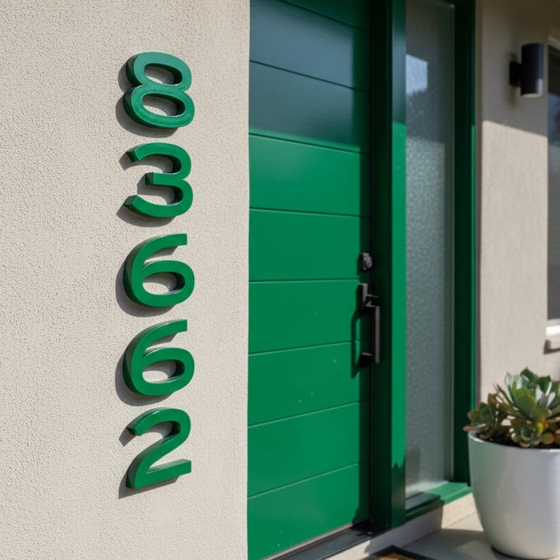 Green house door with house numbers '83662' on a light gray wall.