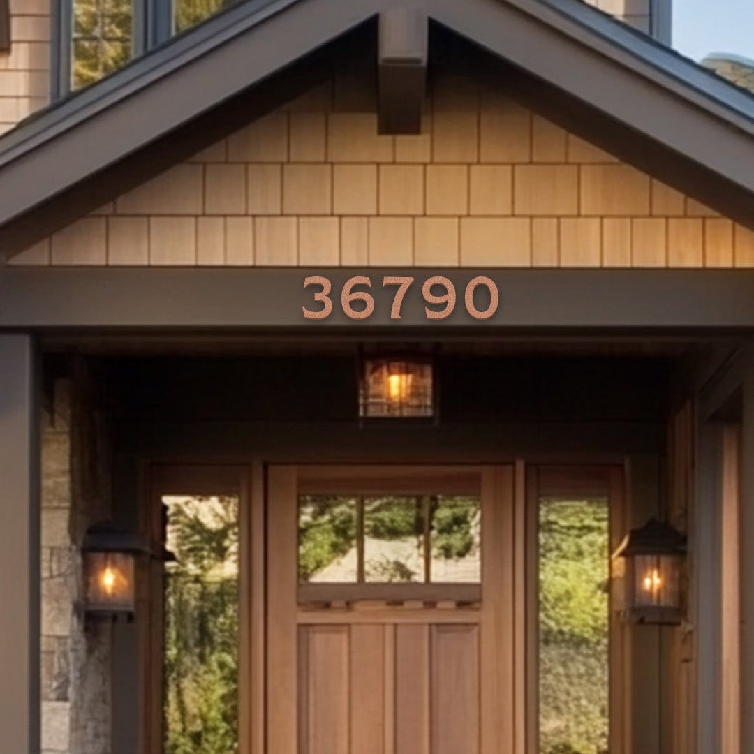 A close-up of a brown wooden door with the number '36790' installed above the entrance, set within a dark brown or black framework, likely on a home exterior.