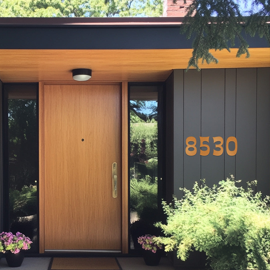 Aztec Copper Magic house numbers in a 1970's style on a grey mid century modern house