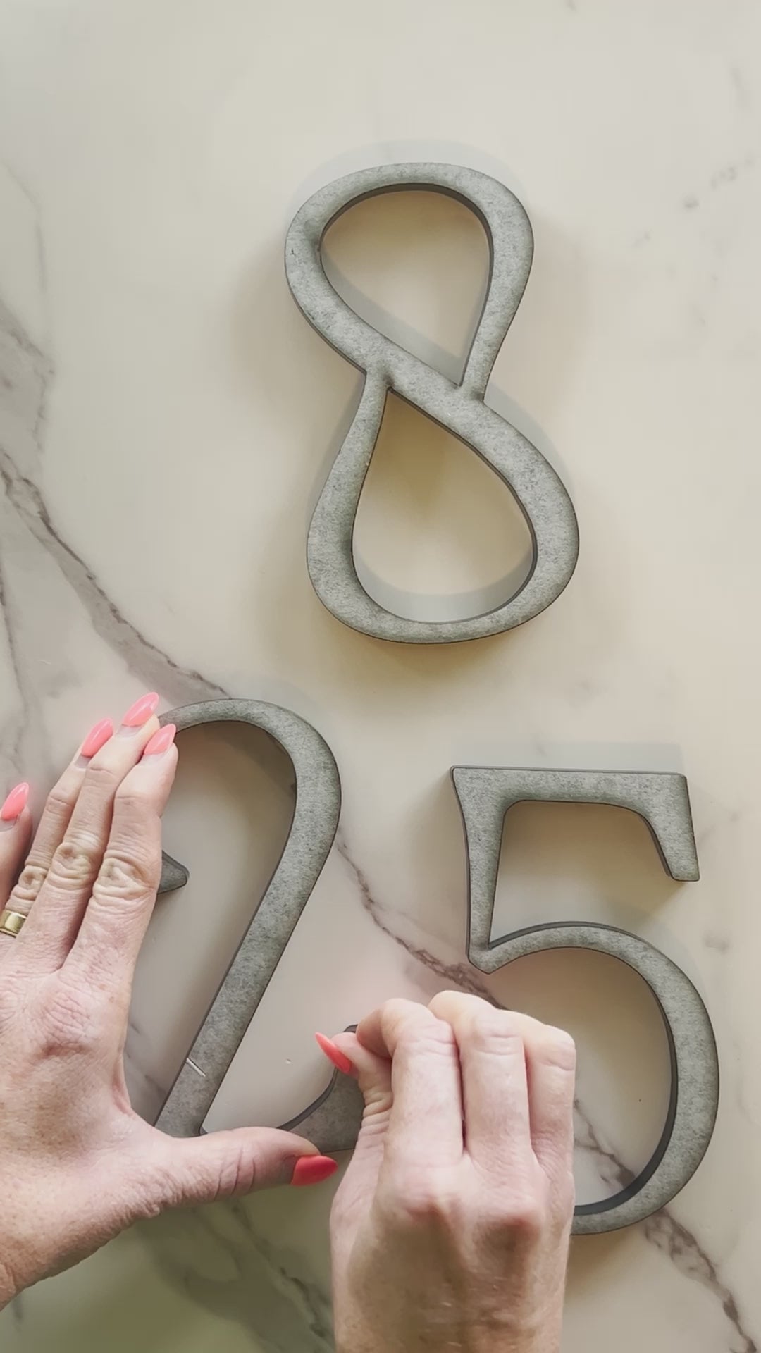 Starting a house number install of 6 inch decorative black address numbers