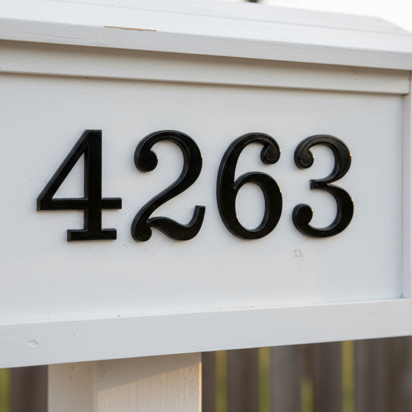House numbers '4263' on a white mailbox with a blurred background