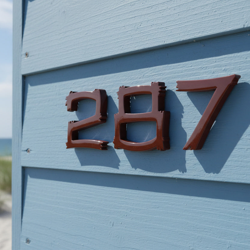 House number '287' on a blue wall with a beach background