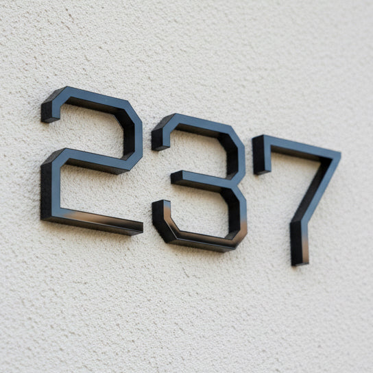 Black house numbers '237' on a textured light gray wall