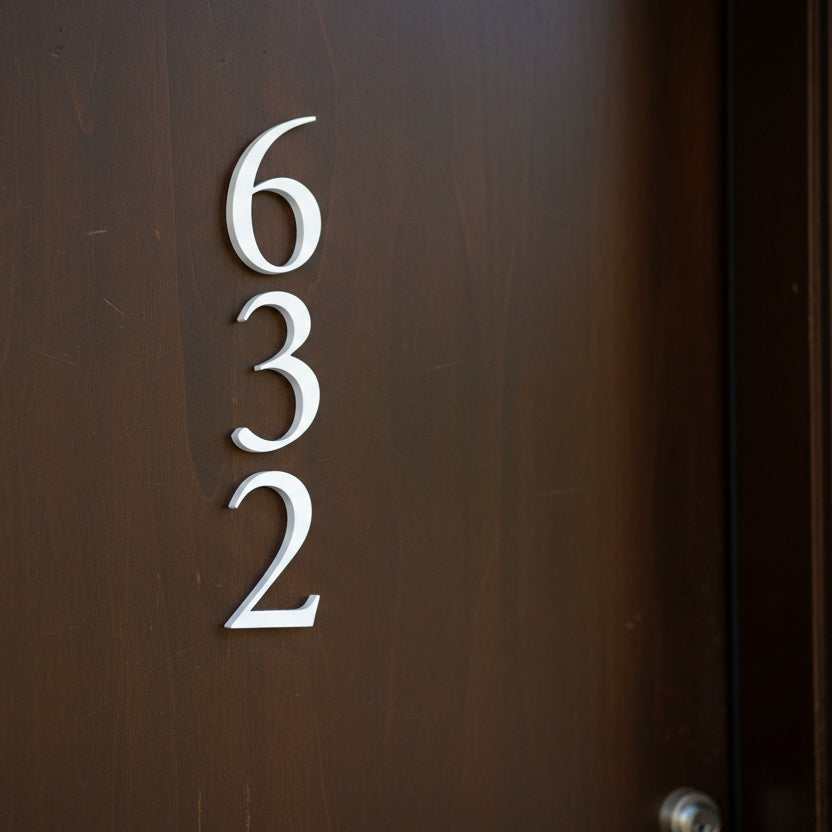 House numbers '632' on a brown door