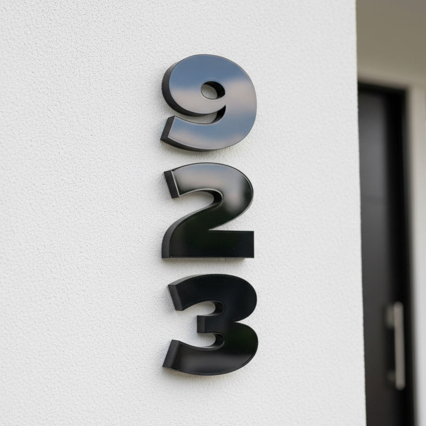 Black house numbers '923' on a white wall