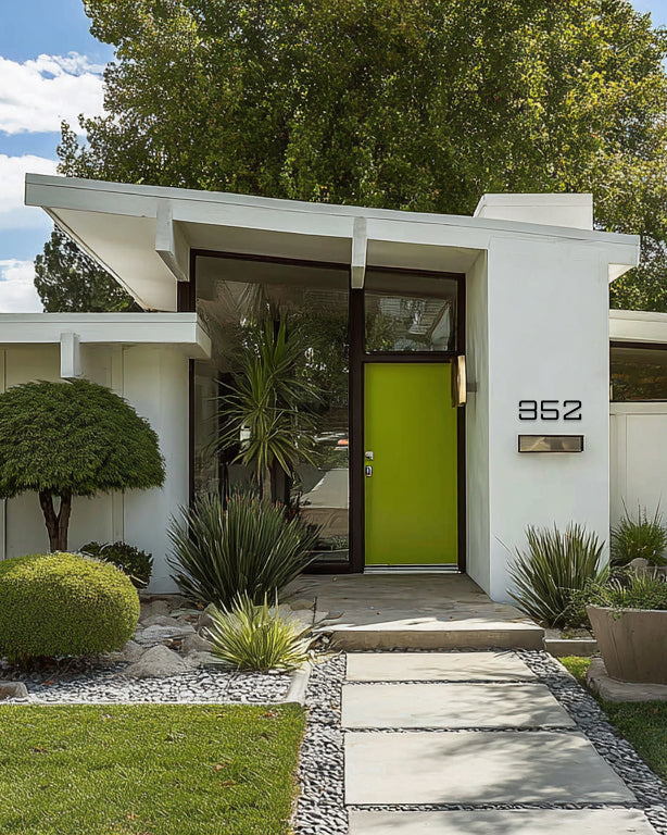 Modern house with a bright green door and white exterior