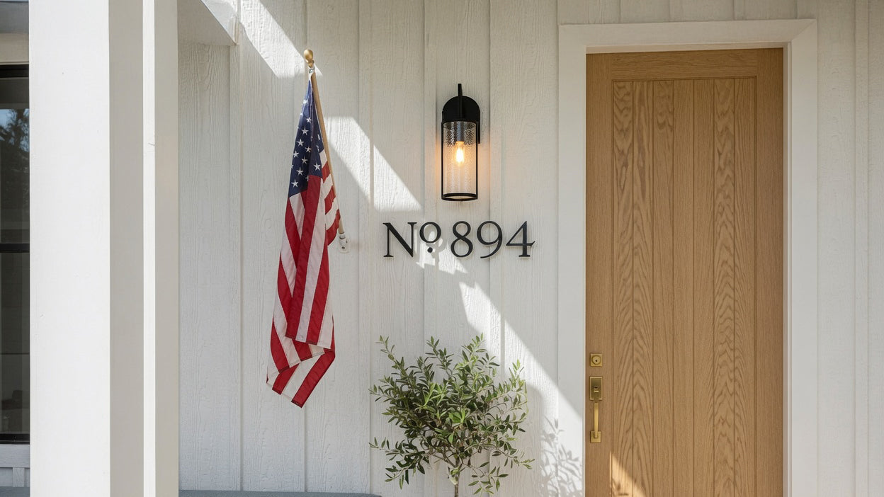 Front door of a house with American flag, light fixture, and address number '894'.
