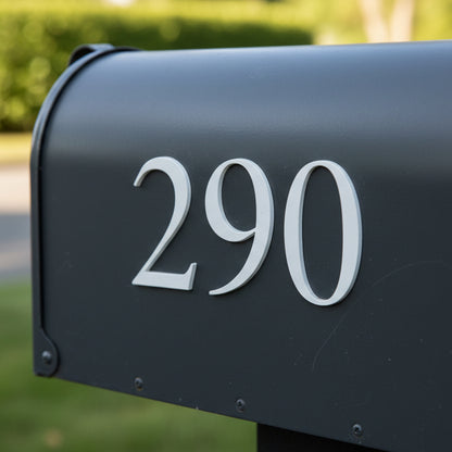 Gray mailbox with house numbers '290' on a blurred green background