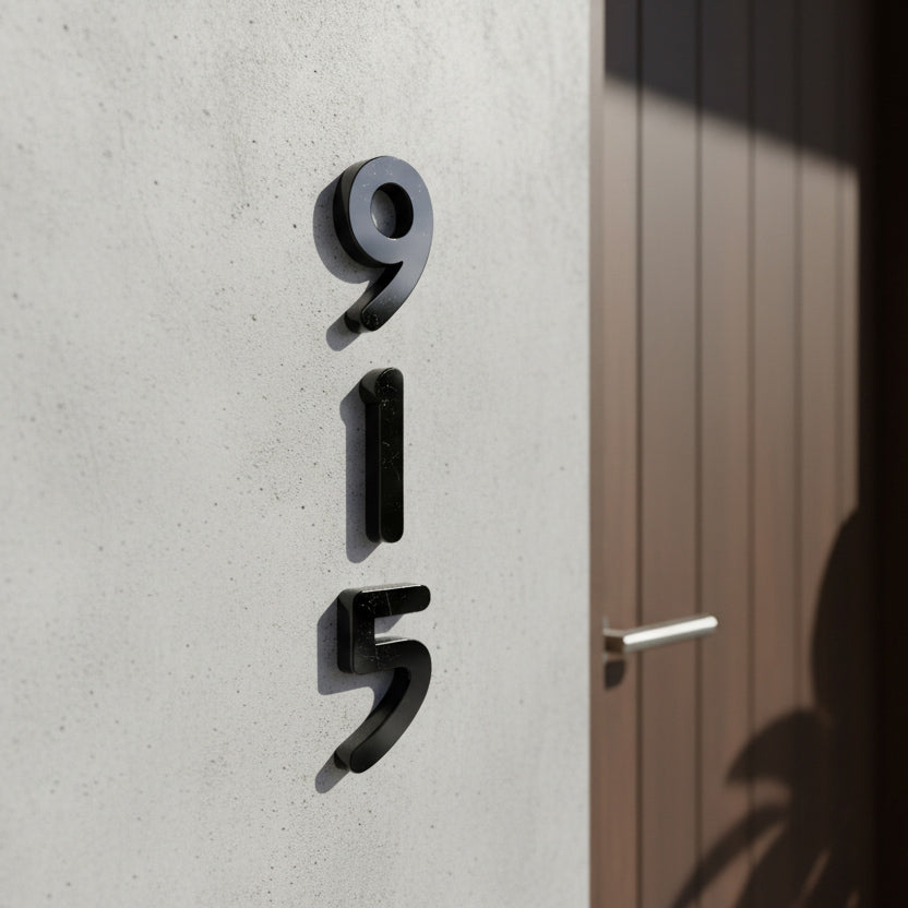 Black Modern house numbers '915' on a concrete wall.