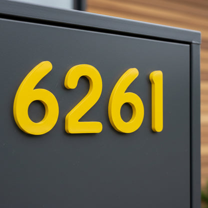 Yellow house numbers '6261' on a gray background