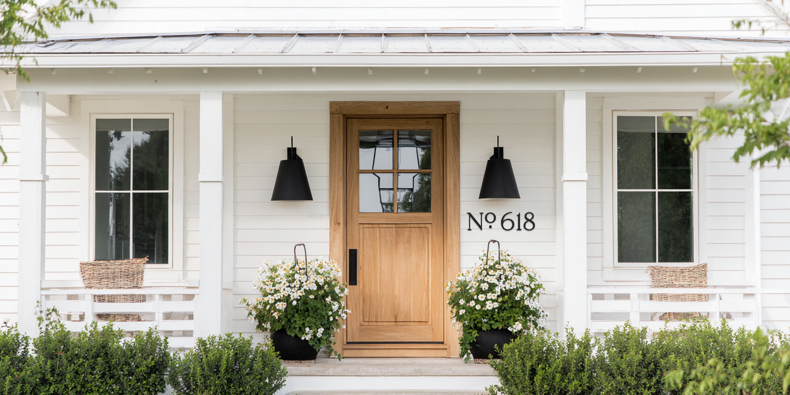 Front door of a house with decorative elements and custom house numbers.