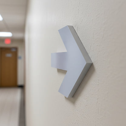 Modern wall-mounted light fixture on a neutral-colored wall