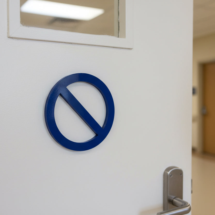 White door with a blue no entry sign and a metallic handle.