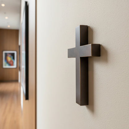Dark Bronze cross on a wall in an indoor setting