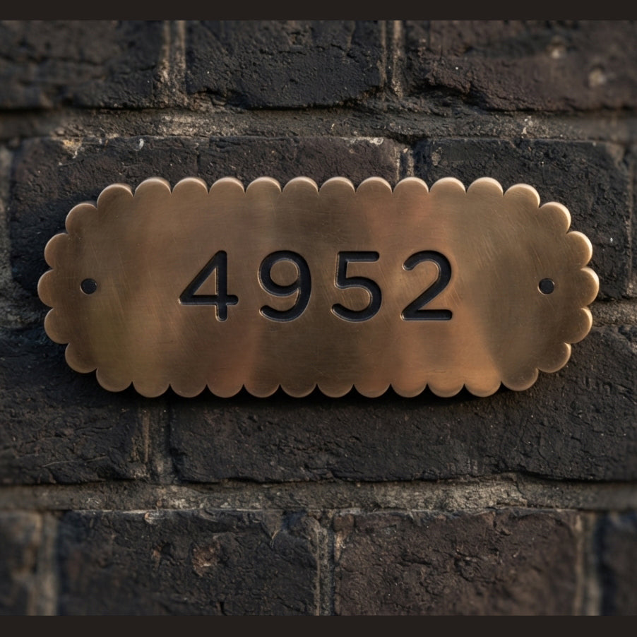 Scalloped edge bronze polished plaque with numbers in the center