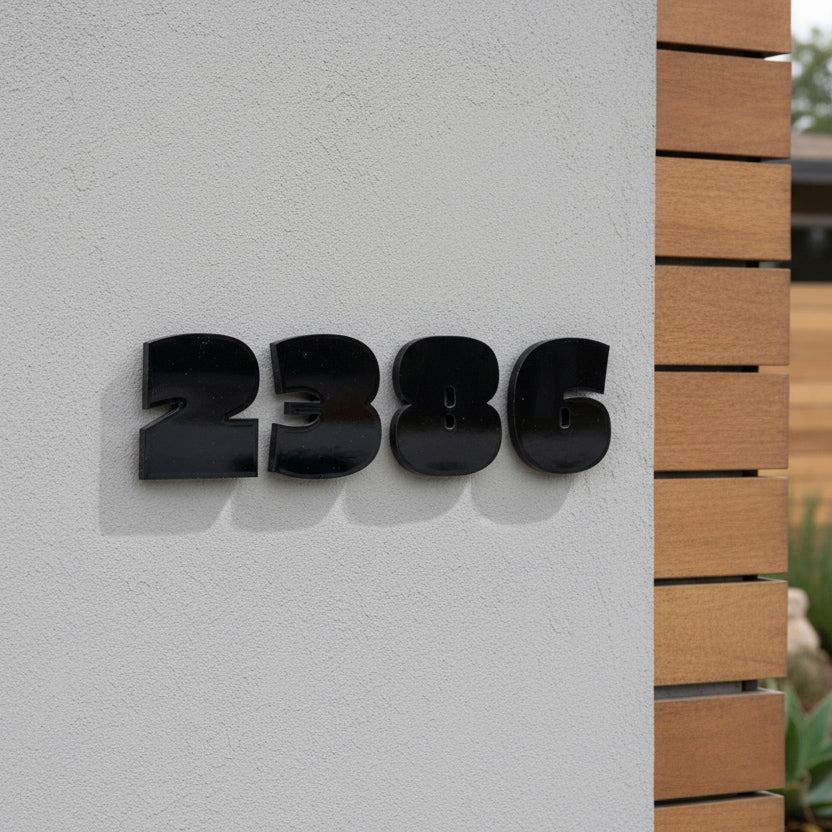 Black house numbers '2386' on a light gray wall with wooden paneling.