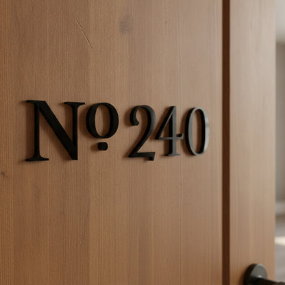 Black acrylic house number 'No 240' mounted on a light brown wooden door.