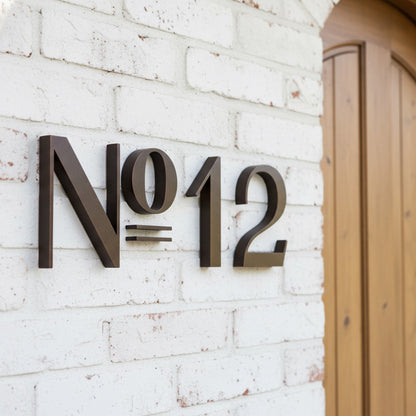 Decorative house number 'N012' on a white brick wall.