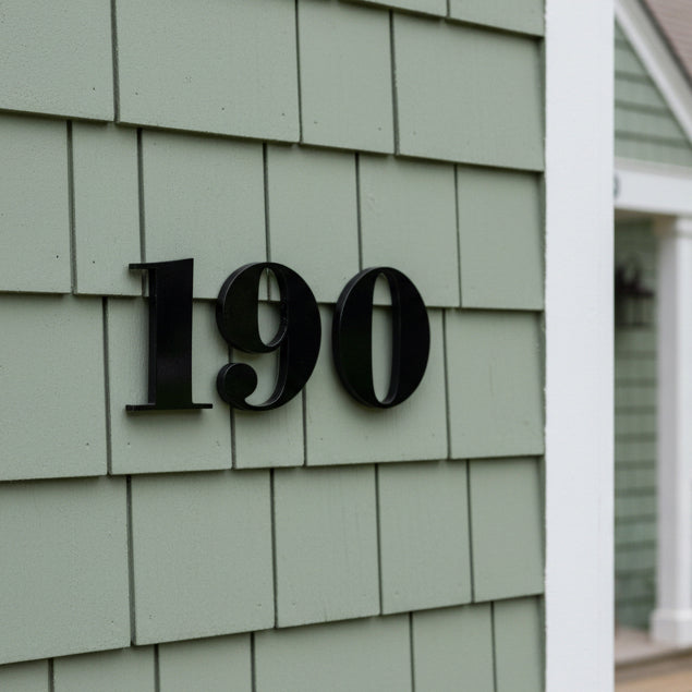 House number '190' on a green shingled wall