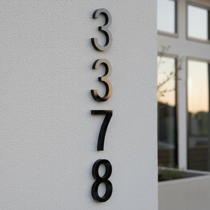 Modern house numbers '3378' on a light gray wall.