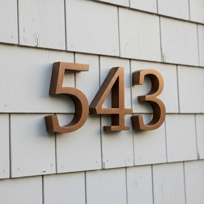 House numbers '543' on a gray shingled wall