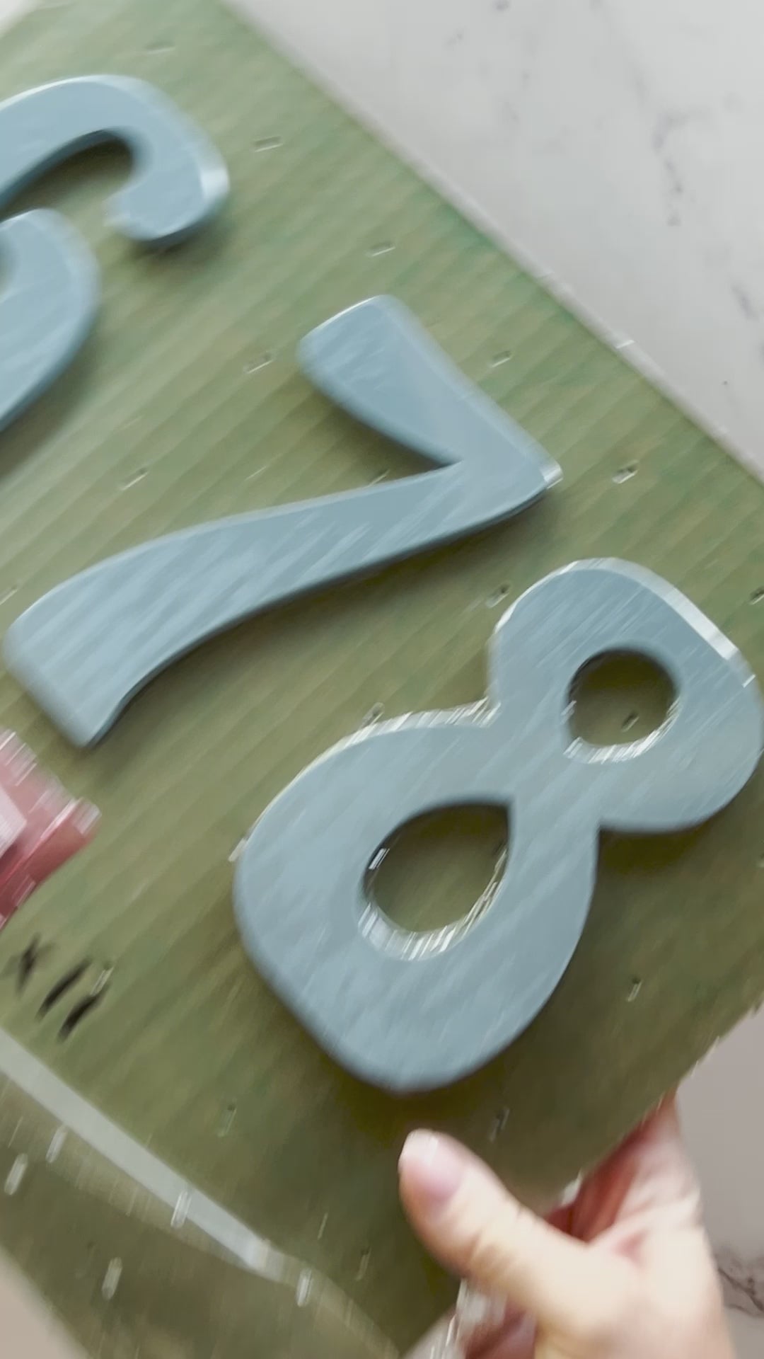 Unpacking Hippy house numbers in light blue painted metal