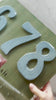 Unpacking Hippy house numbers in light blue painted metal