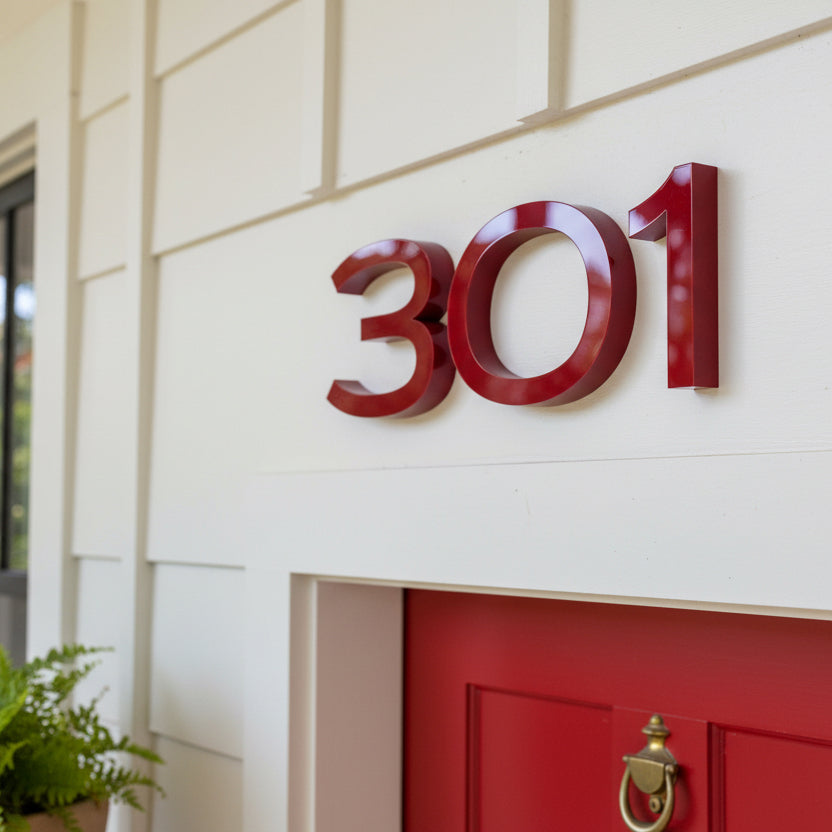Red house number '301' on a white door with a gold doorknob.