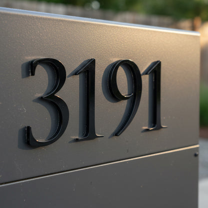 House number '3191' on a metallic plaque with a blurred background
