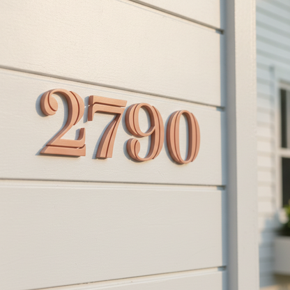 Apricot house number '2790' mounted on a white horizontal siding exterior wall.