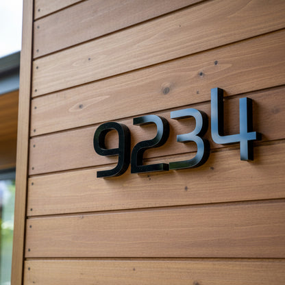 Black house numbers '9234' on a wooden wall