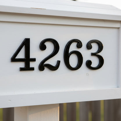 House numbers '4263' on a white mailbox with a blurred background