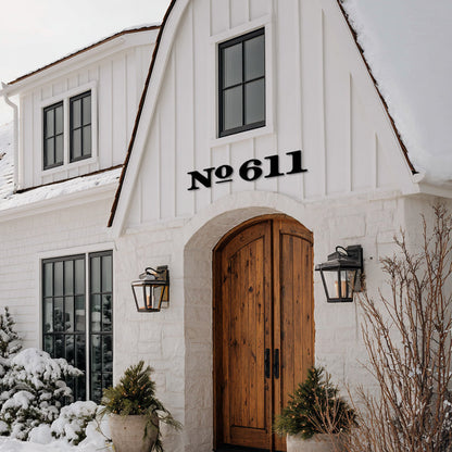 White house with wooden door and snow-covered ground extra large black house numbers