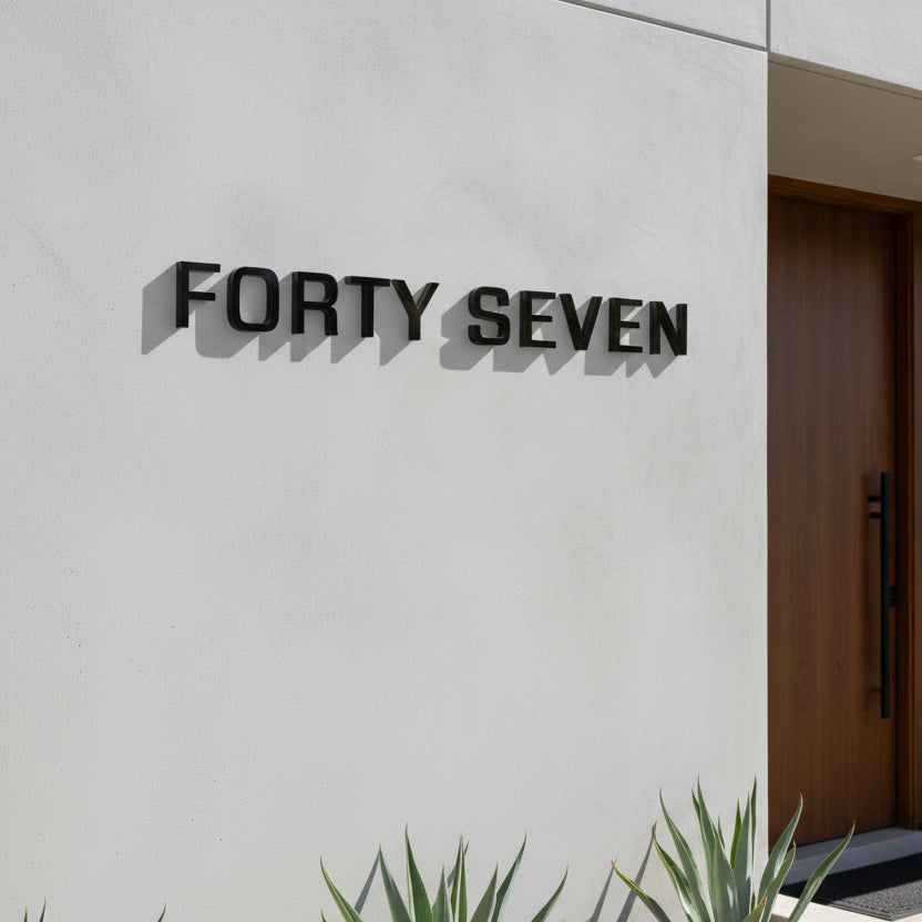 Modern building facade with 'FORTY SEVEN' branding on a white wall.