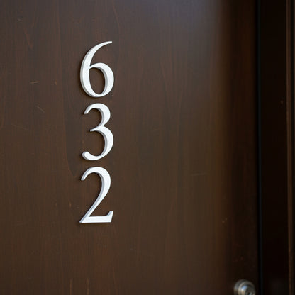 House numbers '632' on a brown door