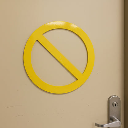 Yellow no entry sign on a beige door with a silver handle.